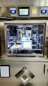 Envirocal technician performing on-site particle counter calibration in a cleanroom environment